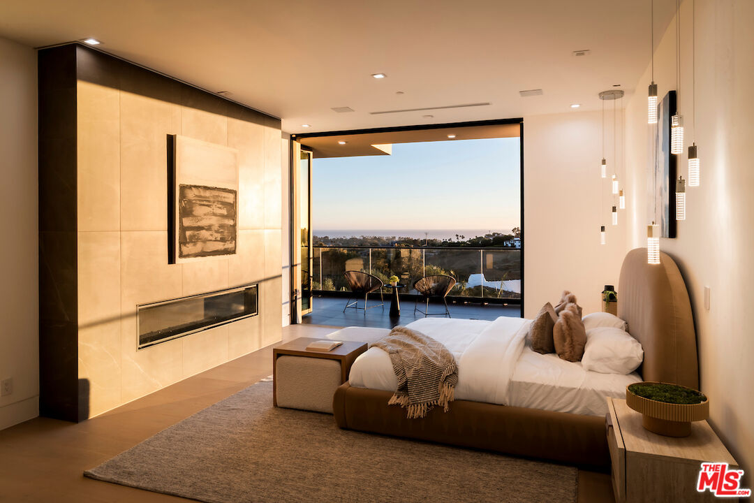 5931 Kanan Dume Road Malibu, CA 90265 - Photo 25 of 50 a bedroom with a large bed and a large window