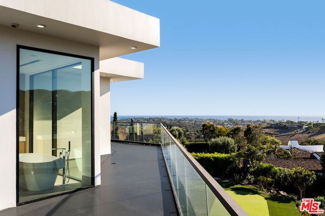 a living room with furniture and large windows