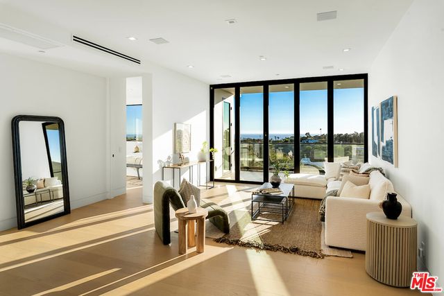 a living room with furniture and a white wall