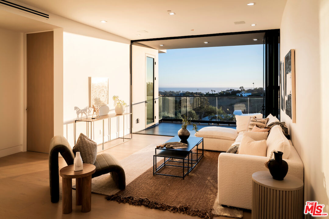 5931 Kanan Dume Road Malibu, CA 90265 - Photo 35 of 50 a living room with furniture and a floor to ceiling window