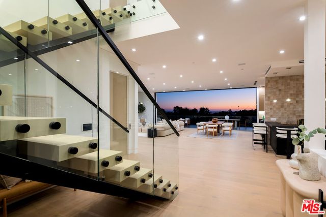 a living room with furniture and a view of kitchen