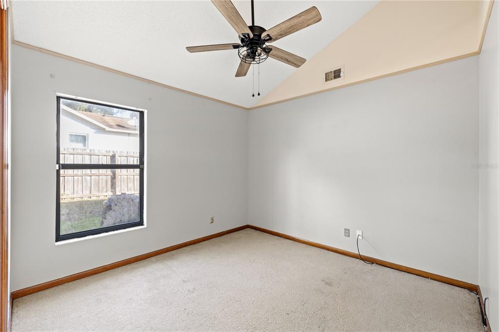 5444 Lighthouse Road Orlando, FL 32808 - Photo 11 of 36 an empty room with a window and a ceiling fan