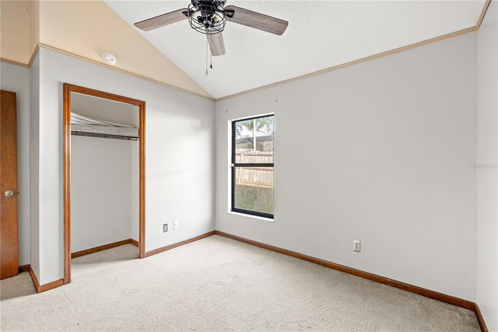 5444 Lighthouse Road Orlando, FL 32808 - Photo 12 of 36 an empty room with a window and a ceiling fan