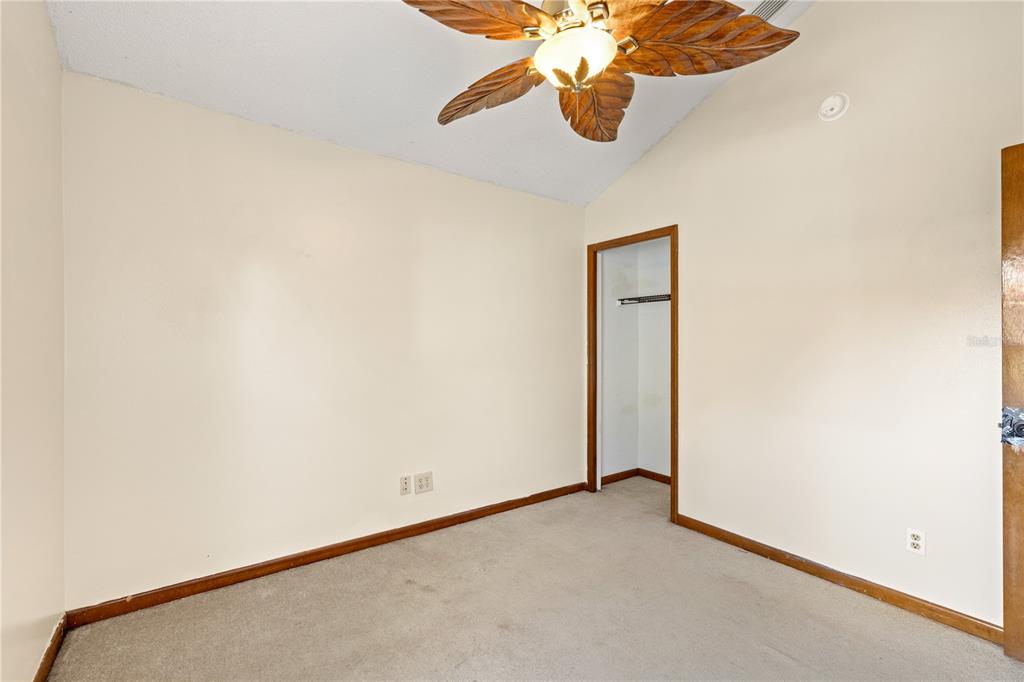 5444 Lighthouse Road Orlando, FL 32808 - Photo 14 of 36 an empty room with a chandelier fan