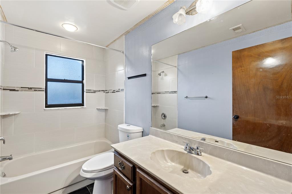 5444 Lighthouse Road Orlando, FL 32808 - Photo 15 of 36 a bathroom with a sink toilet tub and shower