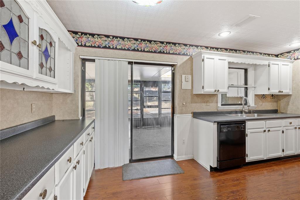 5444 Lighthouse Road Orlando, FL 32808 - Photo 19 of 36 a kitchen with stainless steel appliances granite countertop a refrigerator and a sink
