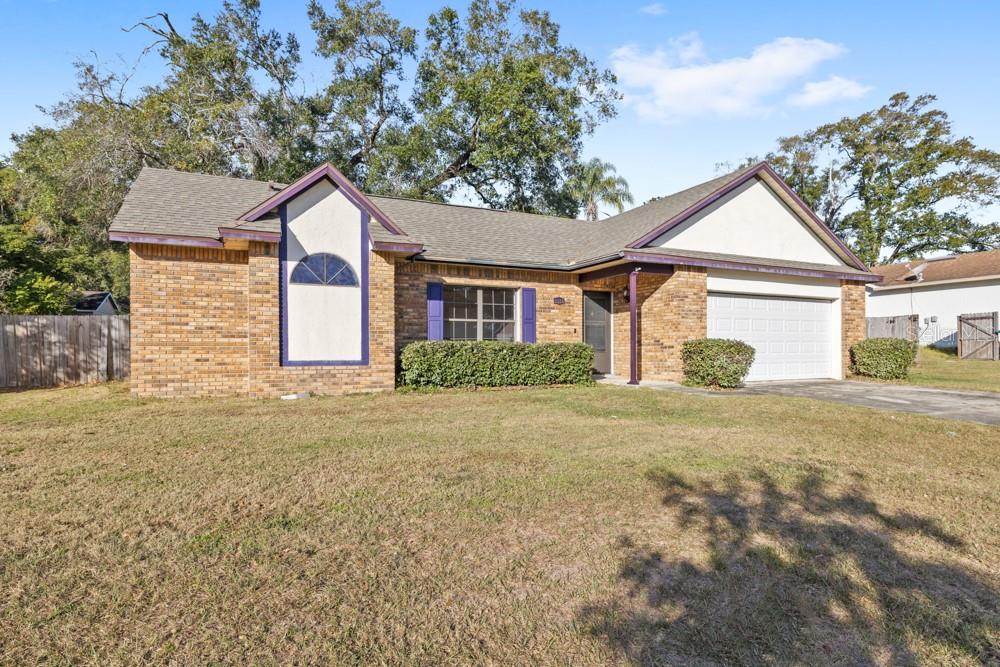 5444 Lighthouse Road Orlando, FL 32808 - Photo 2 of 36 a front view of a house with a yard and garage