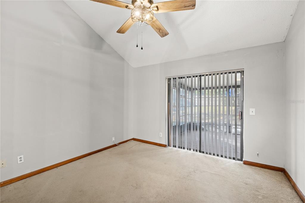 5444 Lighthouse Road Orlando, FL 32808 - Photo 23 of 36 en empty room with windows and ceiling fan