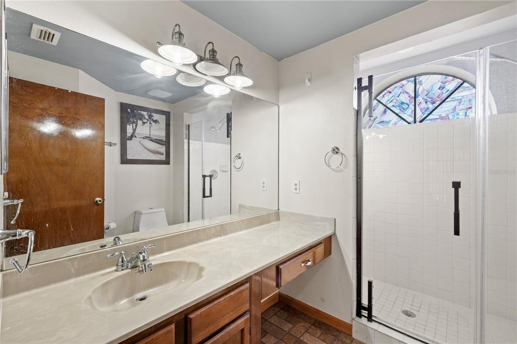 5444 Lighthouse Road Orlando, FL 32808 - Photo 26 of 36 a bathroom with a sink a light fixture and a mirror