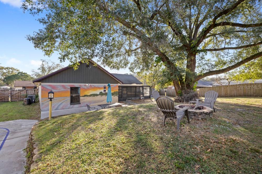5444 Lighthouse Road Orlando, FL 32808 - Photo 33 of 36 a backyard of a house with table and chairs
