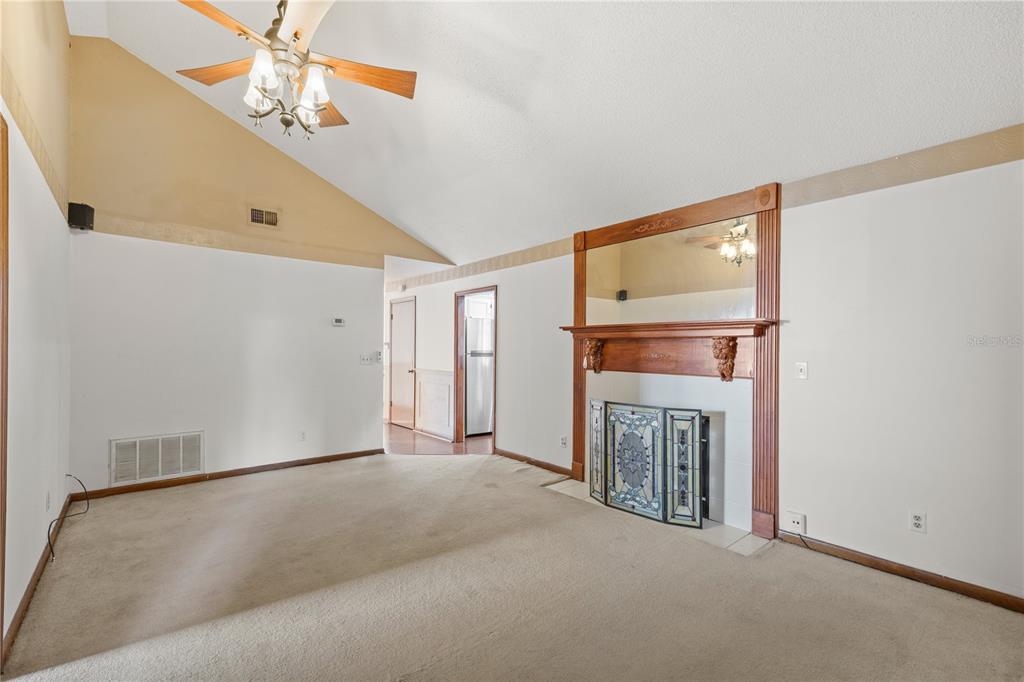 5444 Lighthouse Road Orlando, FL 32808 - Photo 9 of 36 a view of a livingroom with a fireplace