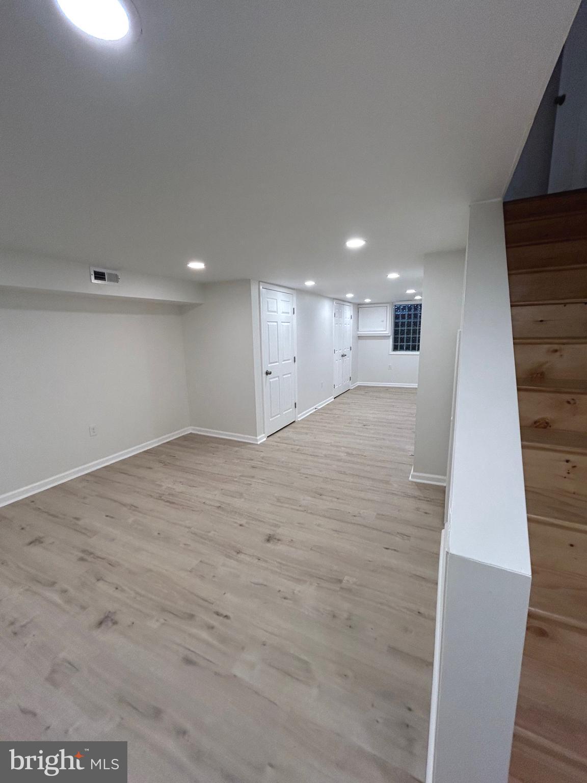 4024 St Augustine Lane Dundalk, MD 21222 - Photo 14 of 17 a view of an empty room with wooden floor and staircase