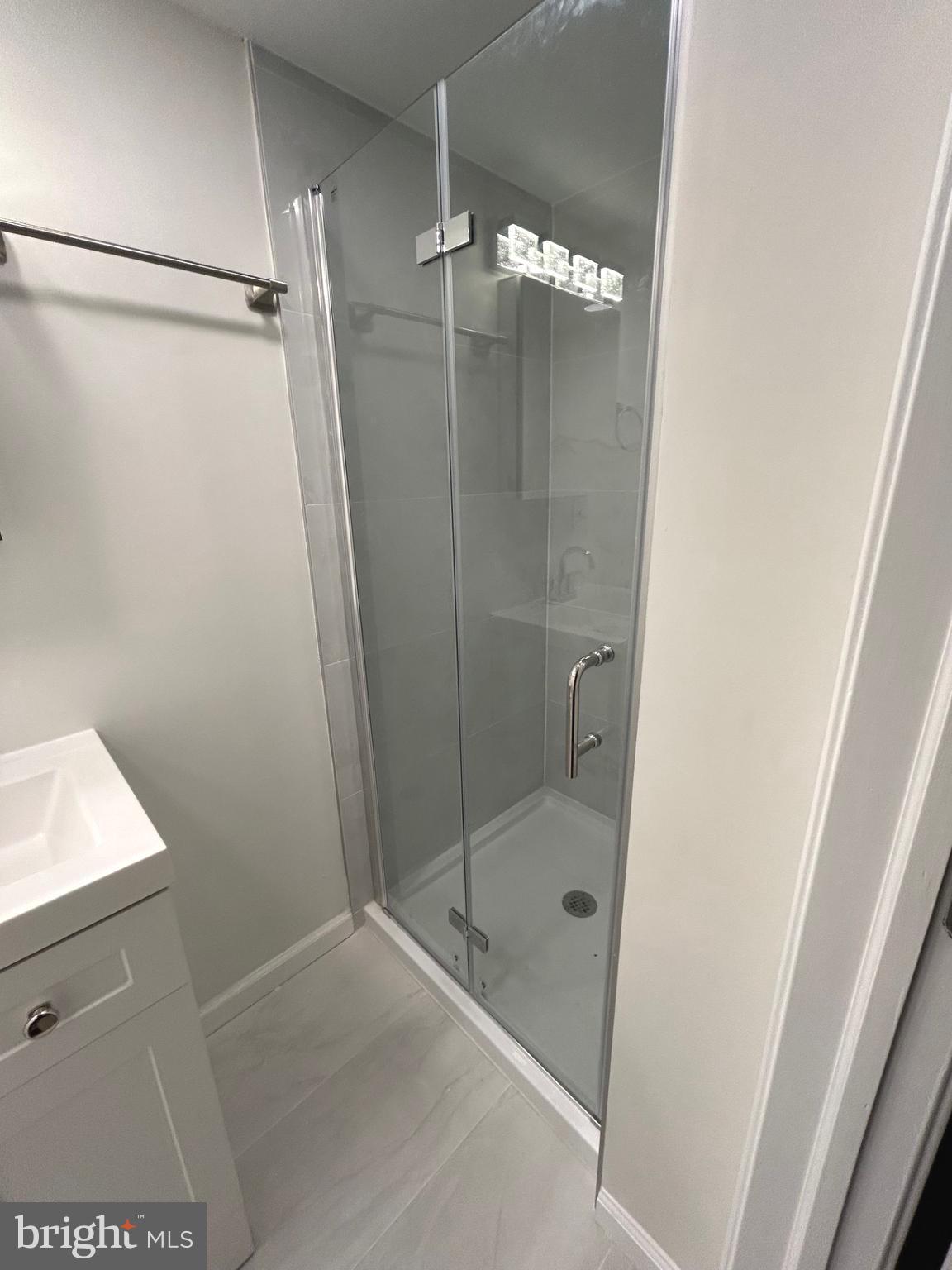 4024 St Augustine Lane Dundalk, MD 21222 - Photo 16 of 17 a bathroom with a glass shower door and a sink