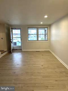 4024 St Augustine Lane Dundalk, MD 21222 - Photo 3 of 17 an empty room with wooden floor and windows