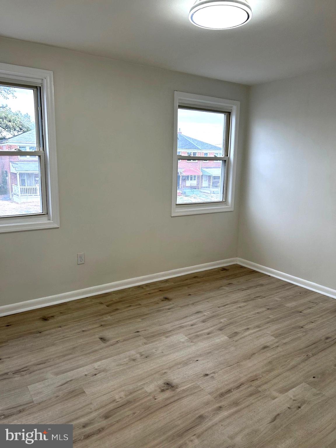 4024 St Augustine Lane Dundalk, MD 21222 - Photo 8 of 17 an empty room with wooden floor and a window