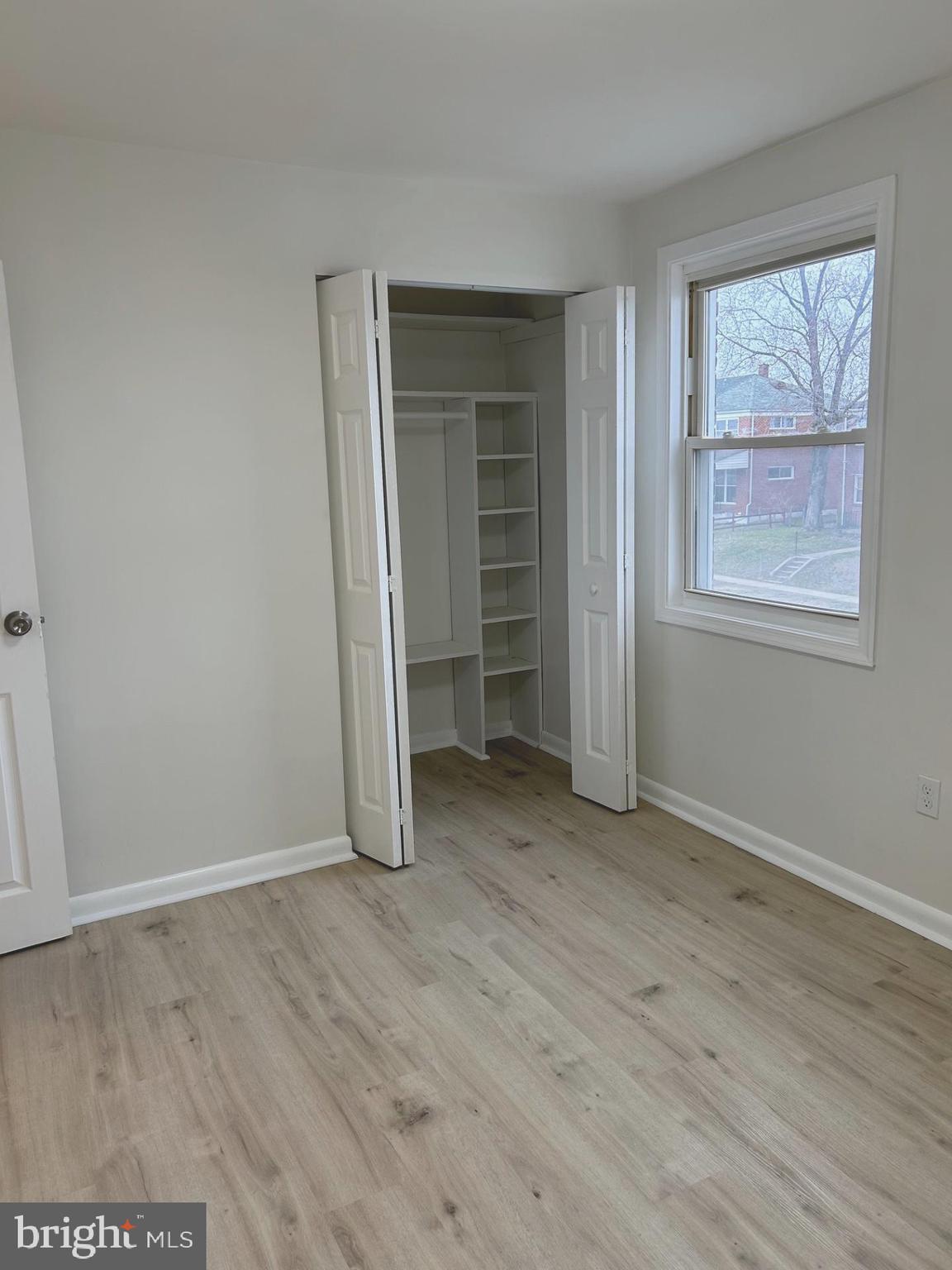 4024 St Augustine Lane Dundalk, MD 21222 - Photo 9 of 17 an empty room with wooden floor and window