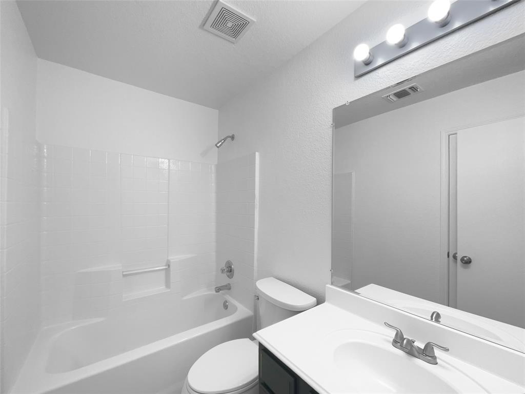 104 Crown Drive Rhome, TX 76078 - Photo 11 of 20 a bathroom with a bathtub shower sink vanity and toilet