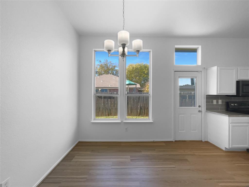 104 Crown Drive Rhome, TX 76078 - Photo 16 of 20 a view of a kitchen with wooden floor and a window