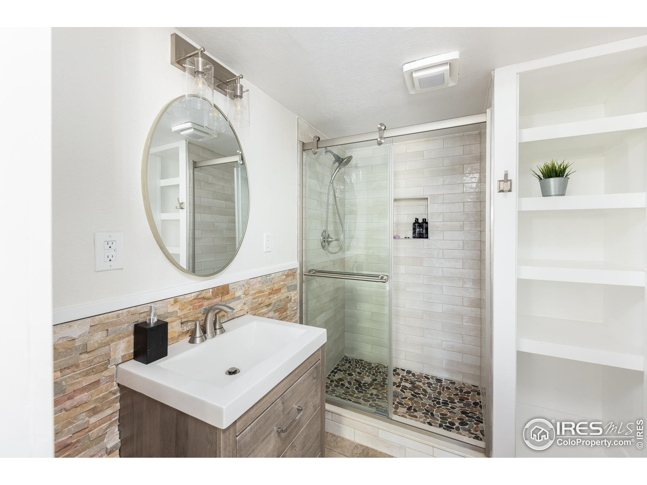 93 Pine Needle Road Boulder, CO 80304 - Photo 13 of 48 a bathroom with a sink a mirror a vanity and a shower