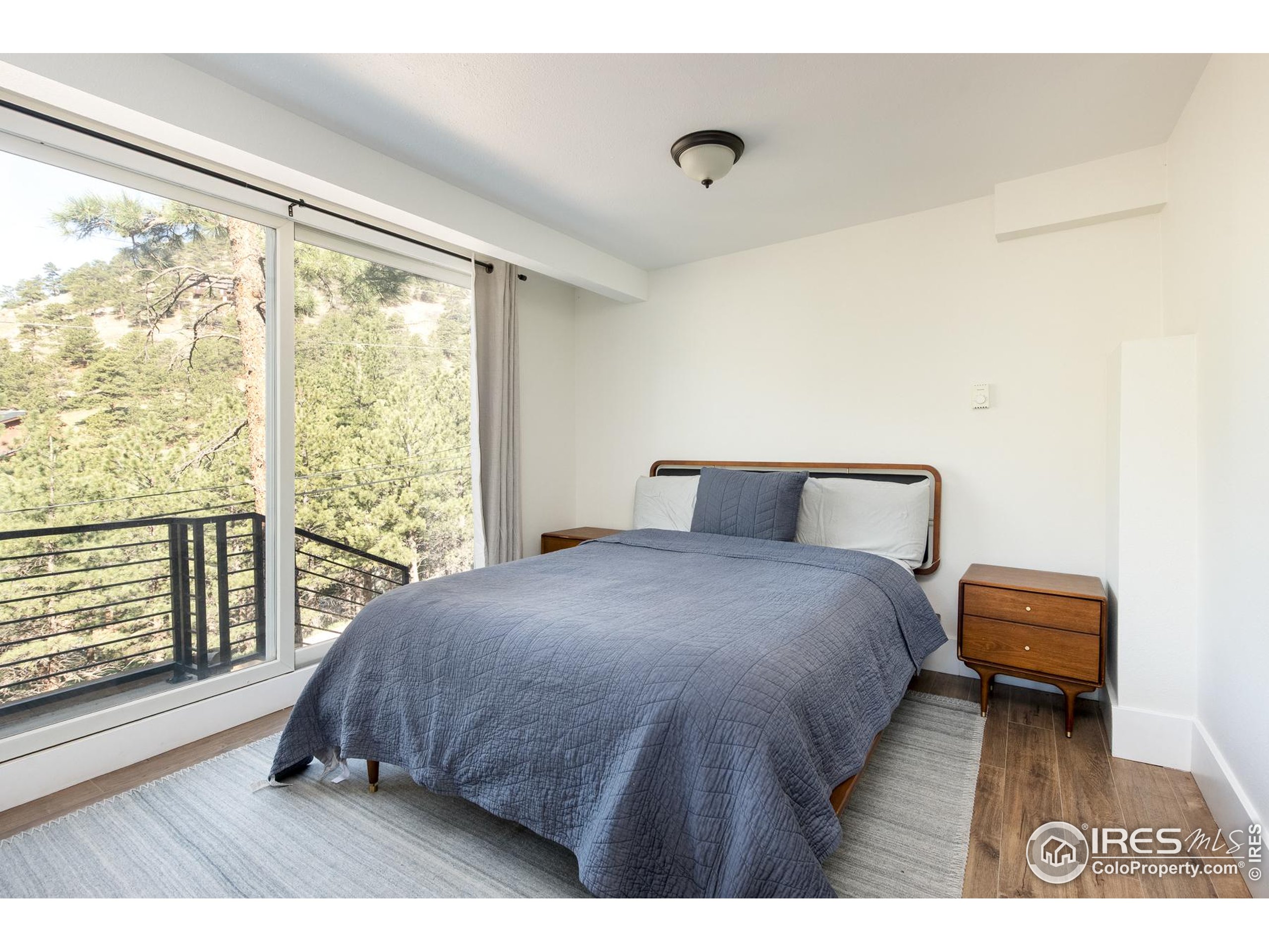 93 Pine Needle Road Boulder, CO 80304 - Photo 14 of 48 a bedroom with a bed and a large window