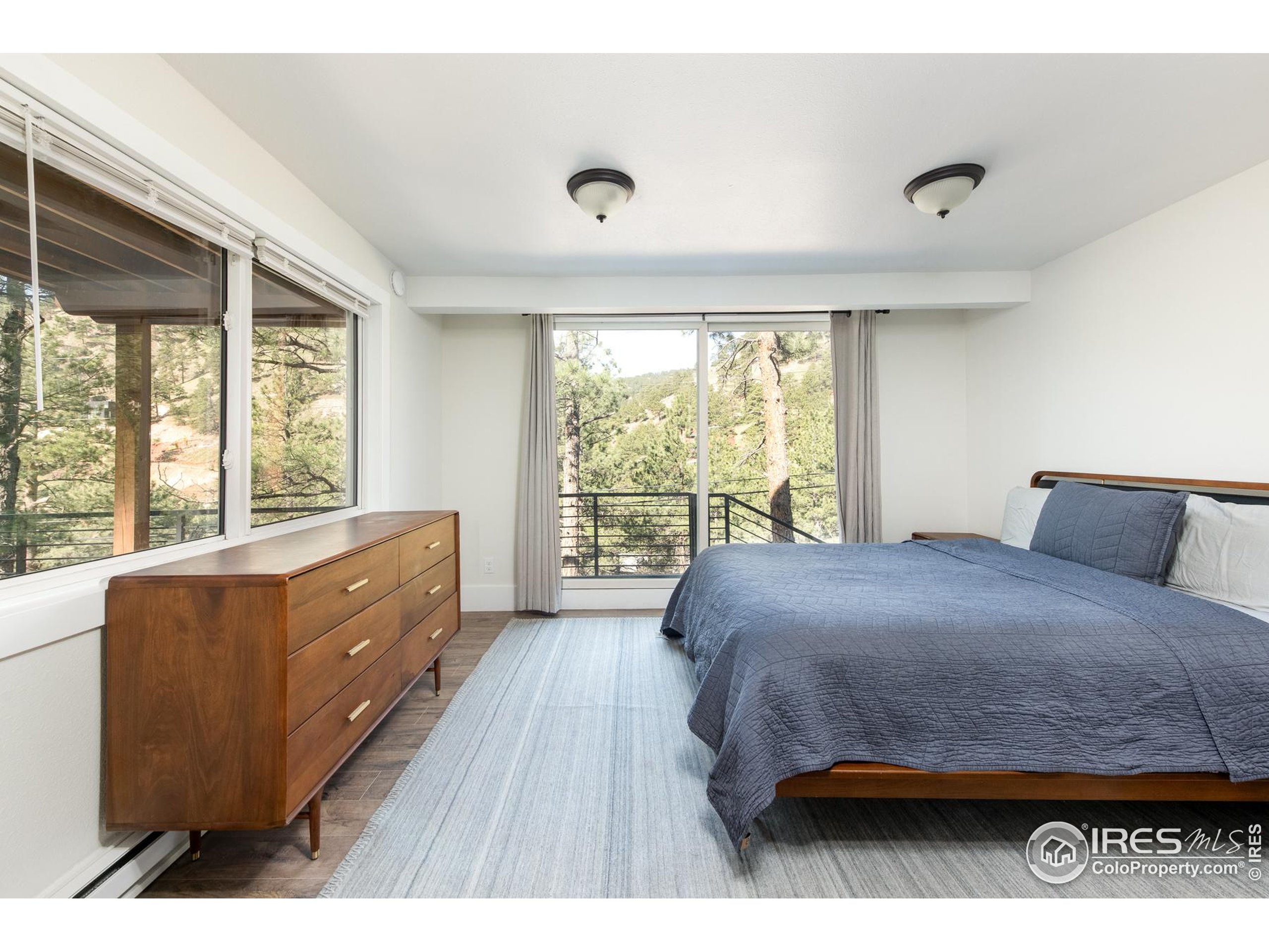 93 Pine Needle Road Boulder, CO 80304 - Photo 16 of 48 a bed room with a bed and a large window