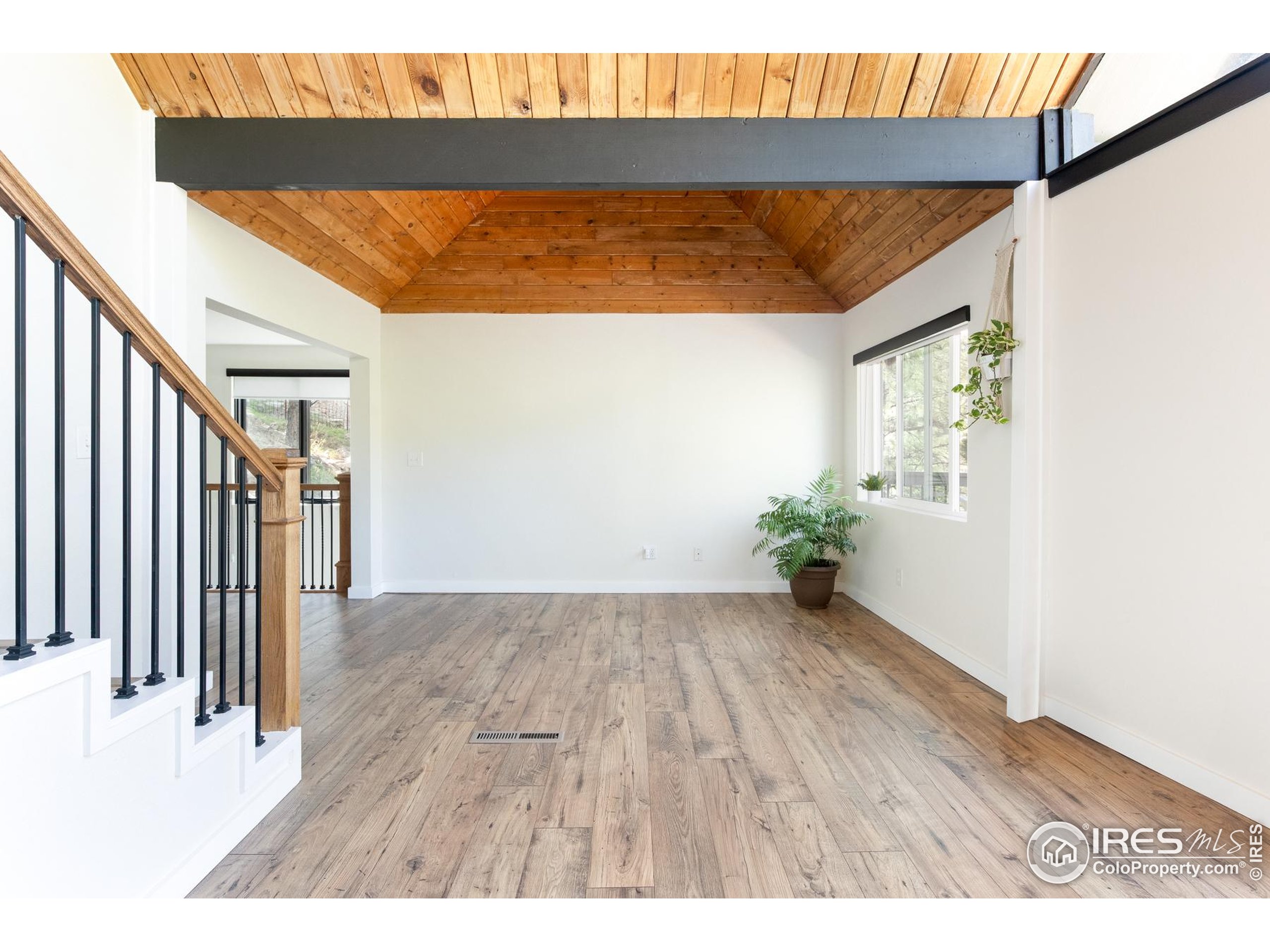 93 Pine Needle Road Boulder, CO 80304 - Photo 19 of 48 a view of a room with wooden floor and a window