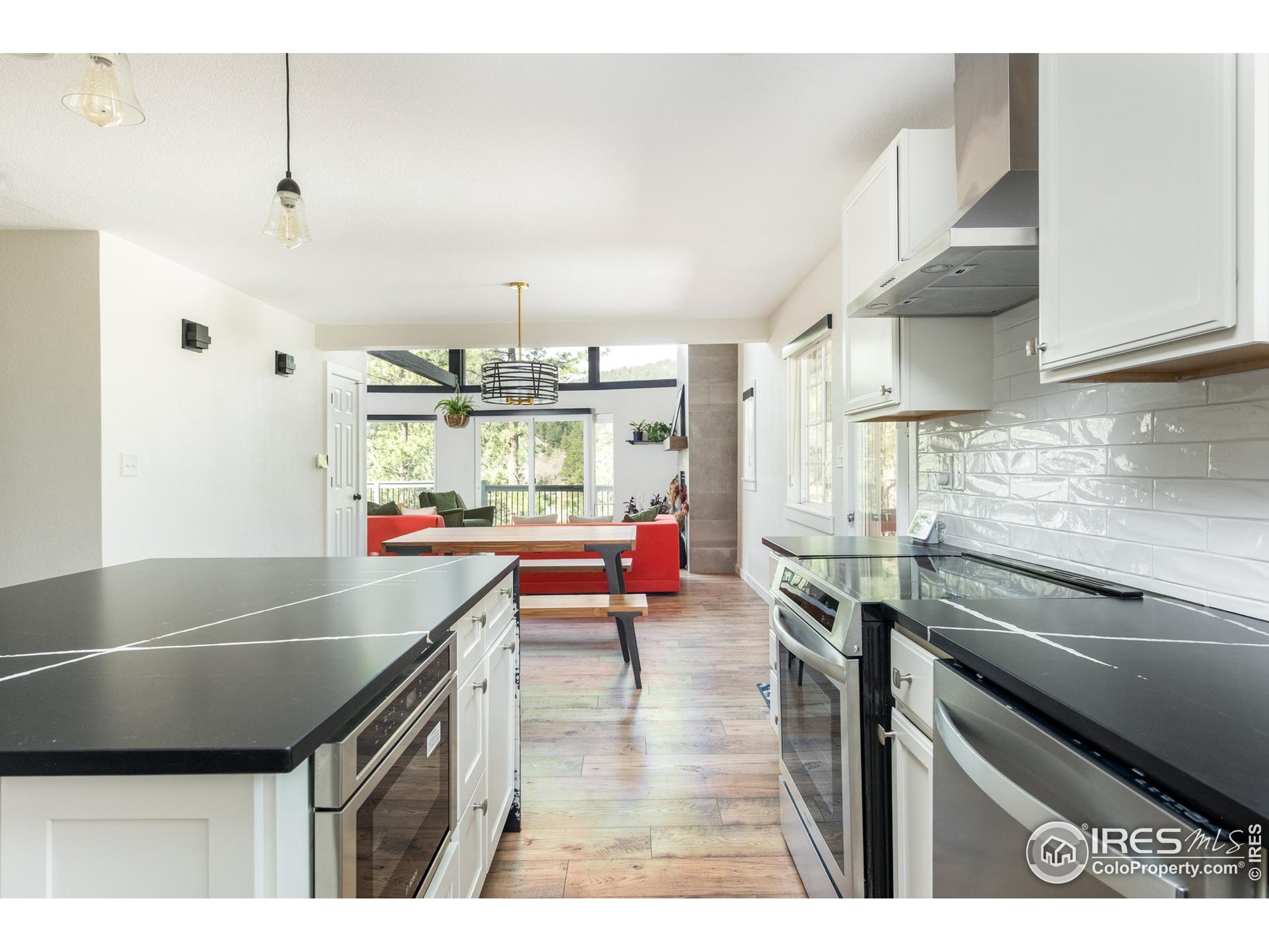 93 Pine Needle Road Boulder, CO 80304 - Photo 30 of 48 a kitchen with stainless steel appliances granite countertop a sink a stove and a wooden cabinets