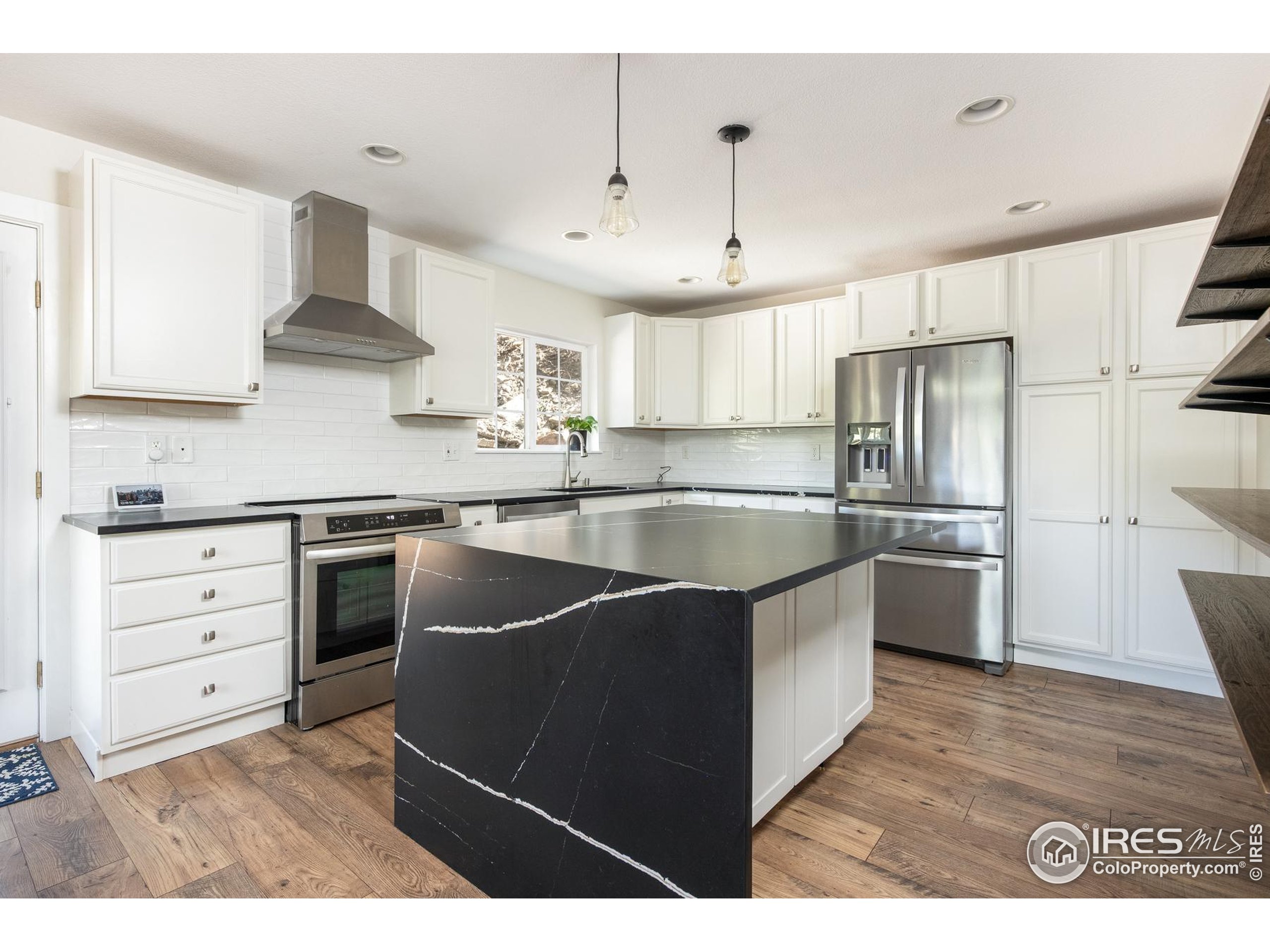 93 Pine Needle Road Boulder, CO 80304 - Photo 39 of 48 a kitchen with kitchen island white cabinets and stainless steel appliances