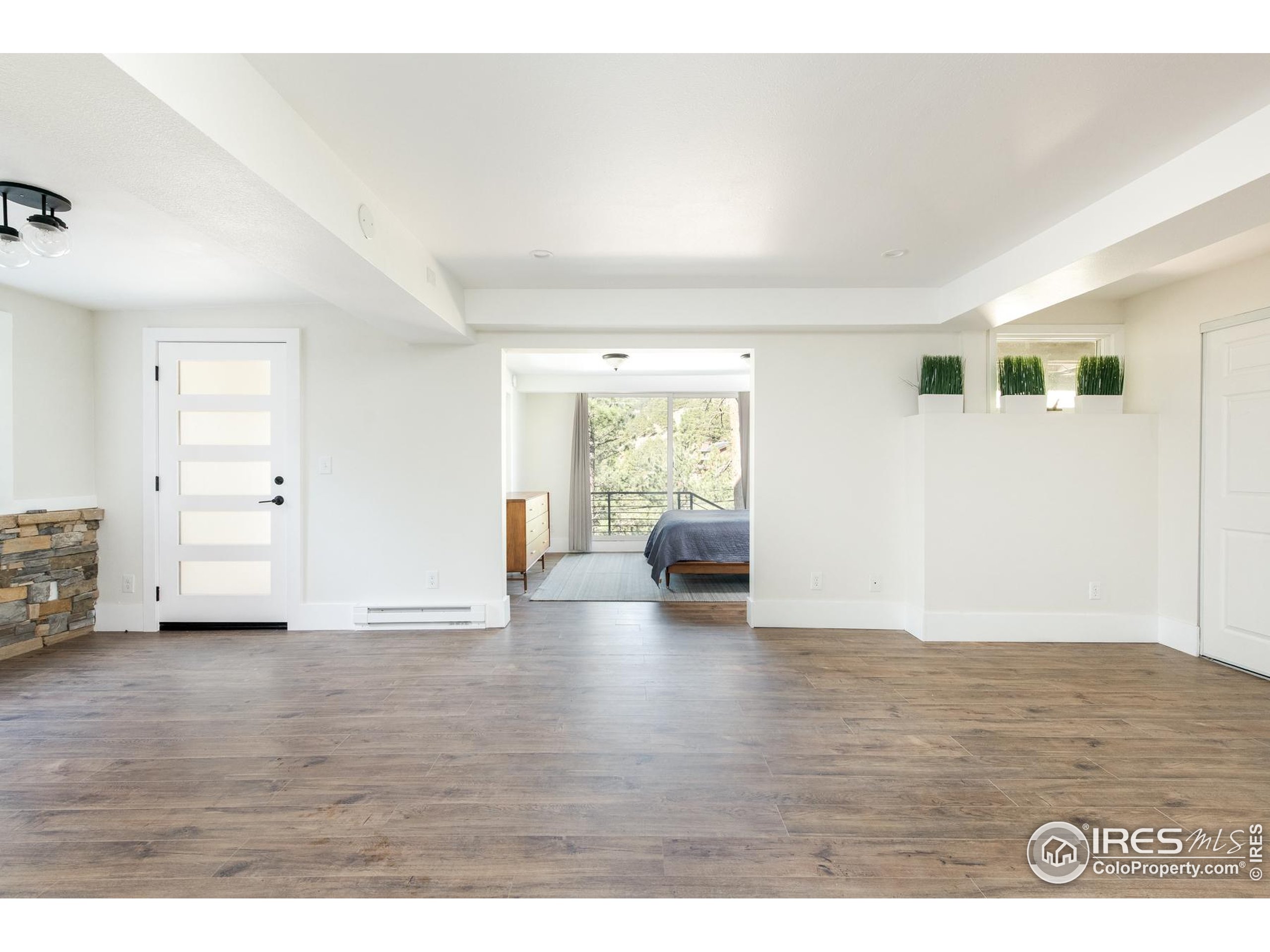 93 Pine Needle Road Boulder, CO 80304 - Photo 10 of 48 a view of an empty room with wooden floor and a window