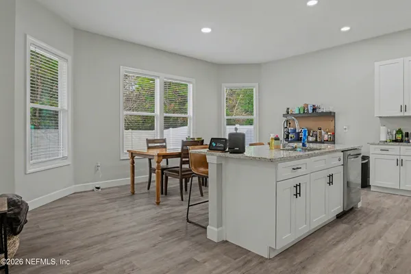 a kitchen with sink cabinets and wooden floor