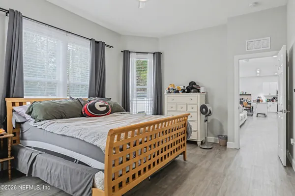 a bedroom with furniture and a large window