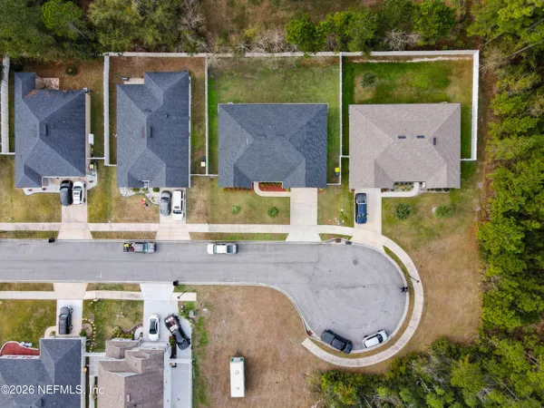 an aerial view of a house with swimming pool and outdoor space