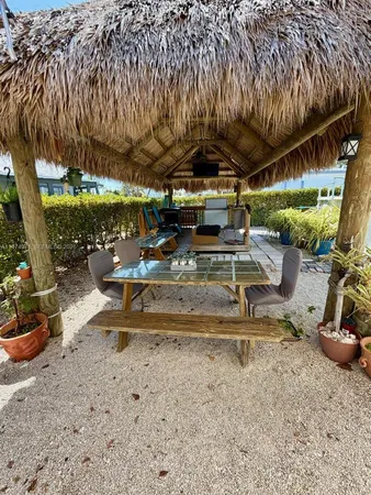 a view of a porch with chairs and potted plants