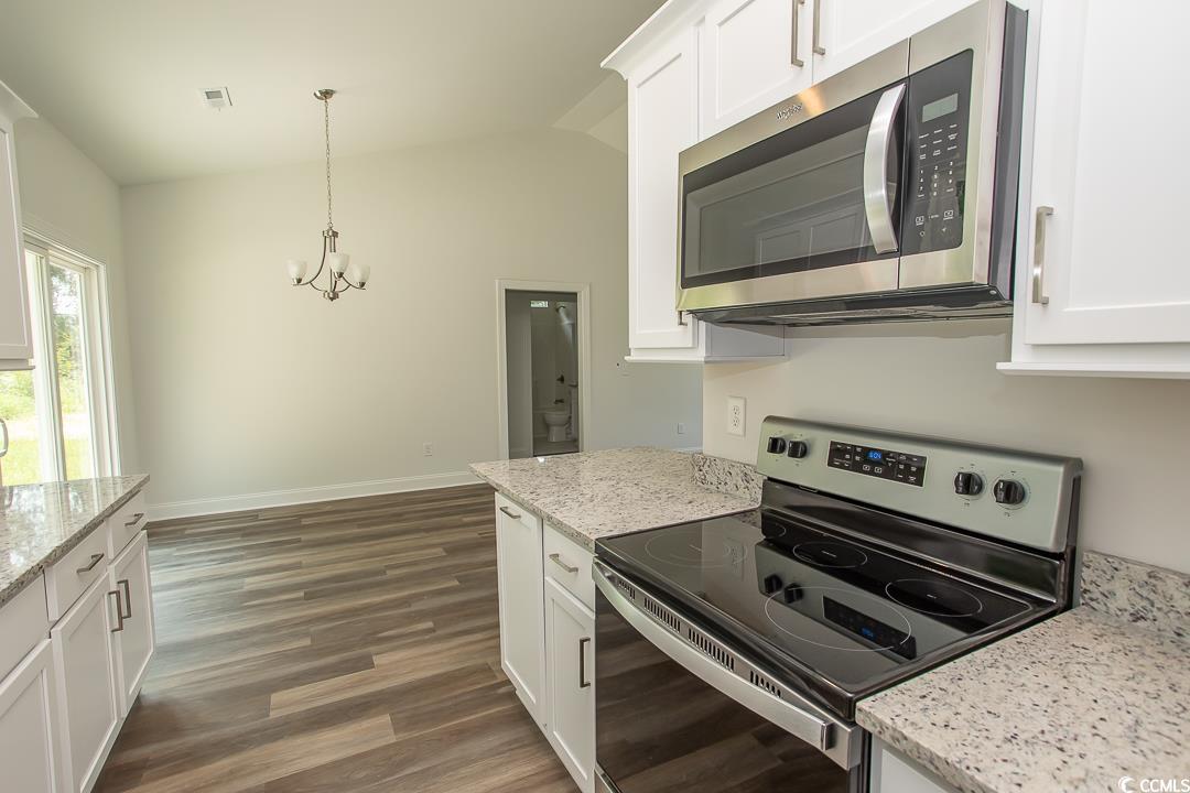 3858 Red Bluff Road Loris, SC 29569 - Photo 11 of 29 Kitchen with white cabinetry, appliances with stai