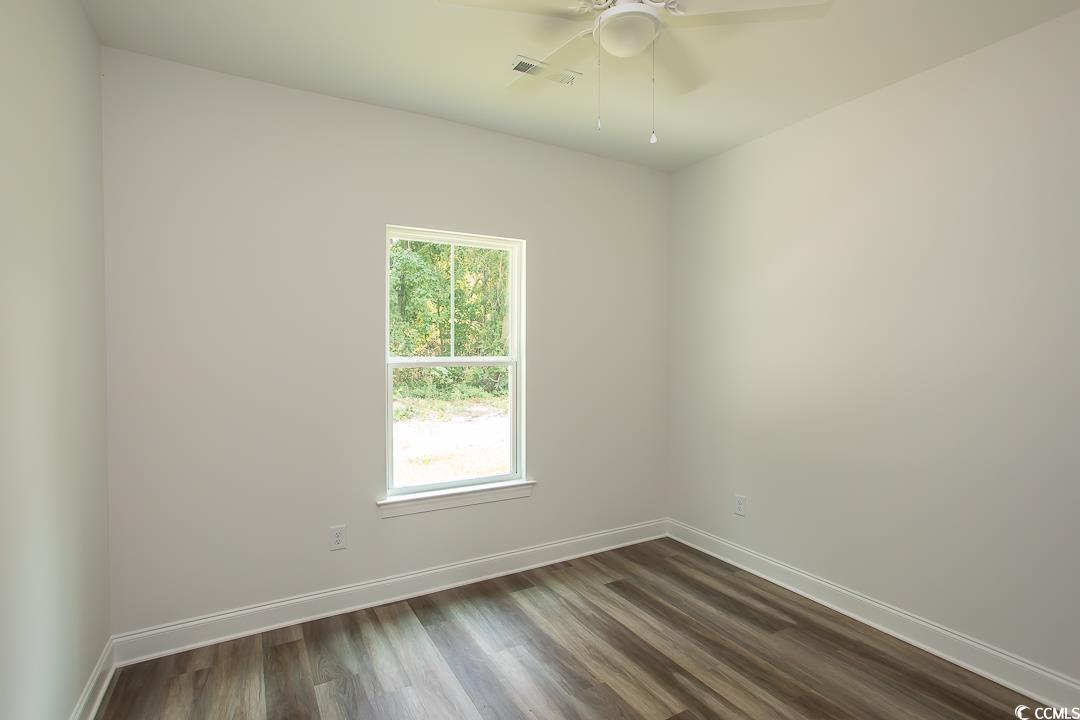 3858 Red Bluff Road Loris, SC 29569 - Photo 22 of 29 Unfurnished room with dark hardwood / wood-style f