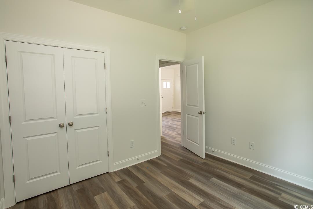 3858 Red Bluff Road Loris, SC 29569 - Photo 24 of 29 Unfurnished bedroom with a closet and dark hardwoo