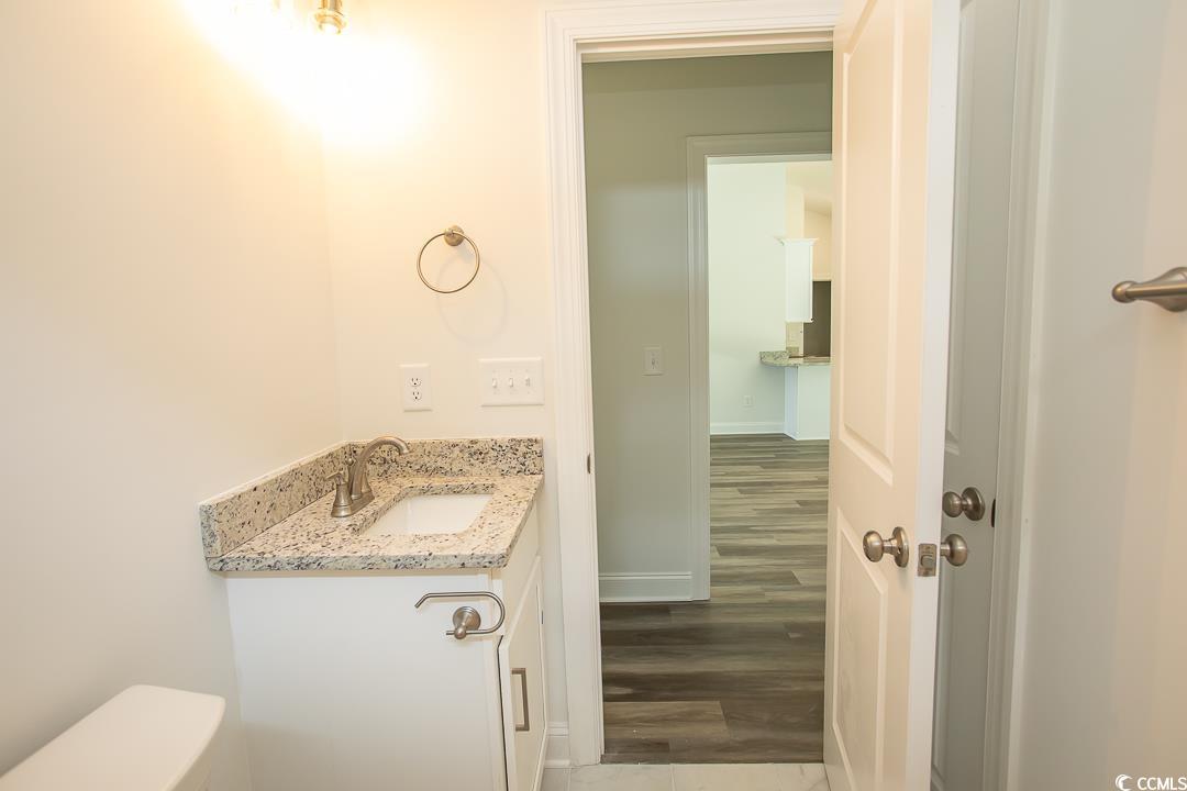 3858 Red Bluff Road Loris, SC 29569 - Photo 27 of 29 Bathroom with hardwood / wood-style flooring, vani