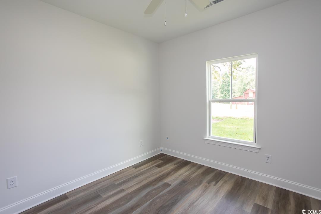 3858 Red Bluff Road Loris, SC 29569 - Photo 28 of 29 Empty room featuring dark wood-type flooring, a he