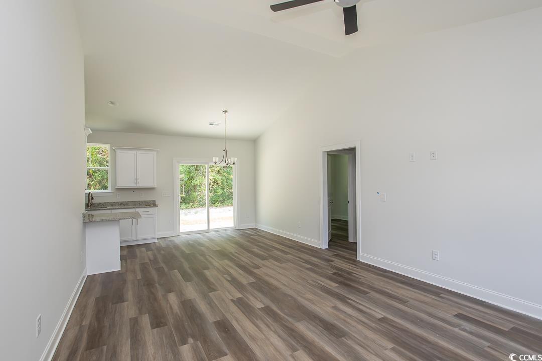 3858 Red Bluff Road Loris, SC 29569 - Photo 4 of 29 Unfurnished living room with dark wood-type floori
