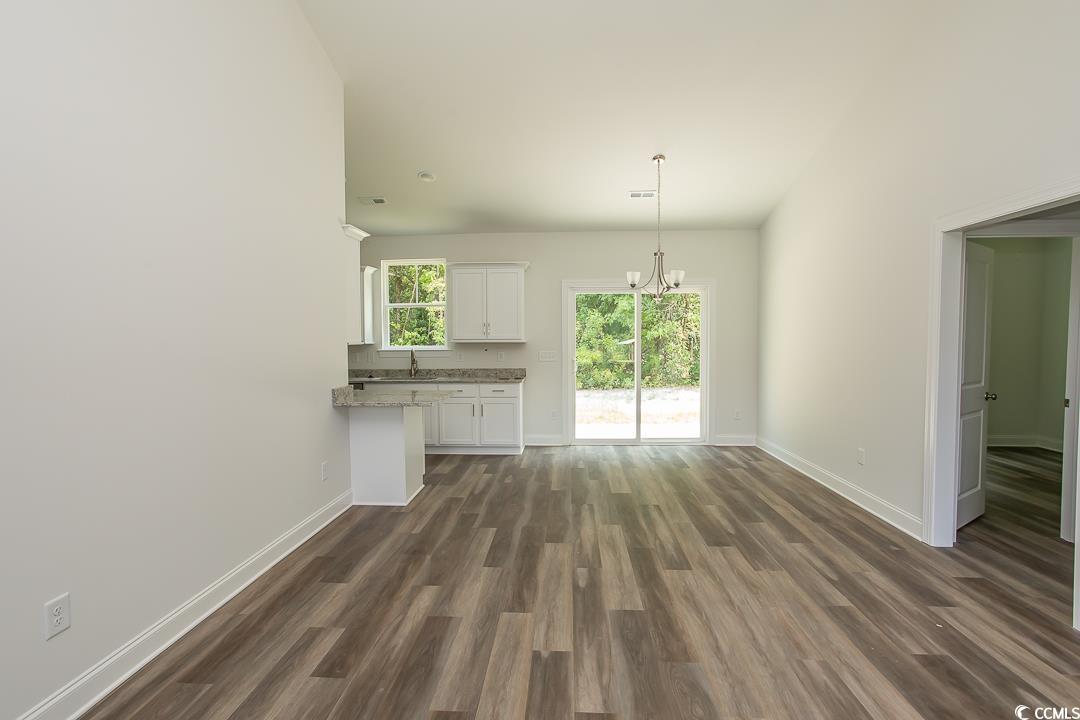 3858 Red Bluff Road Loris, SC 29569 - Photo 5 of 29 Unfurnished living room with dark wood-type floori