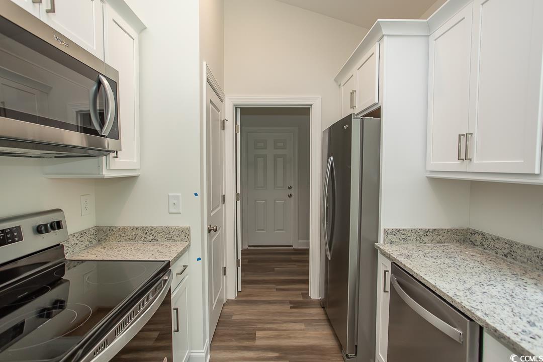 3858 Red Bluff Road Loris, SC 29569 - Photo 8 of 29 Kitchen featuring white cabinetry, light stone cou