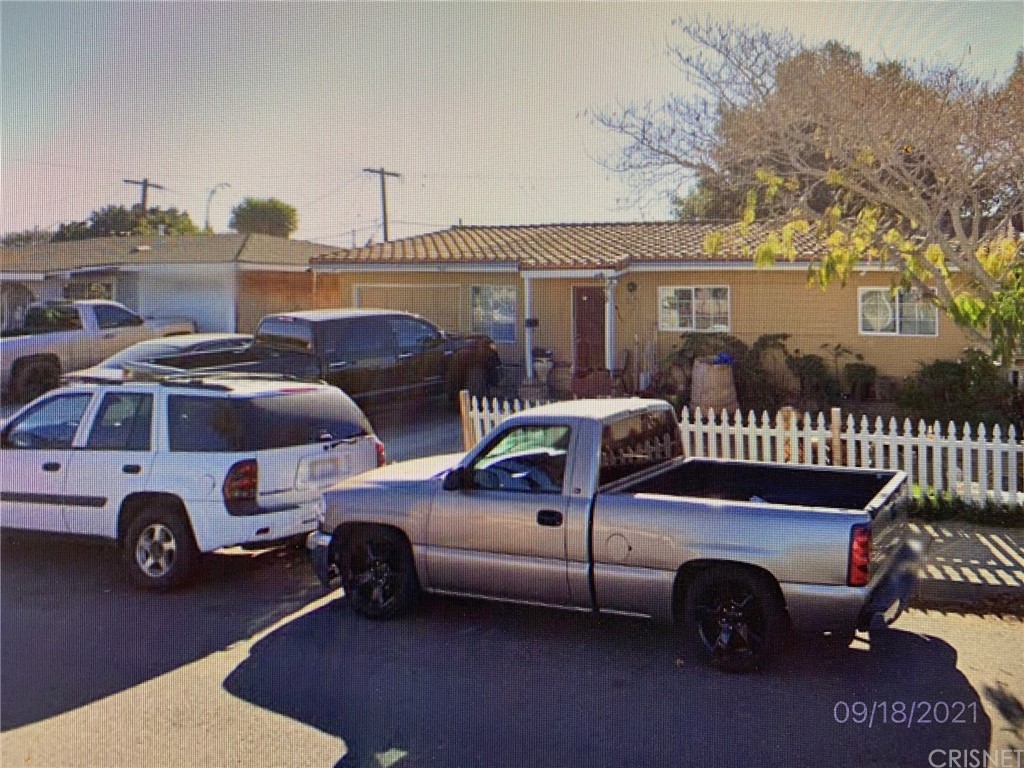 a view of a cars park in front of a house