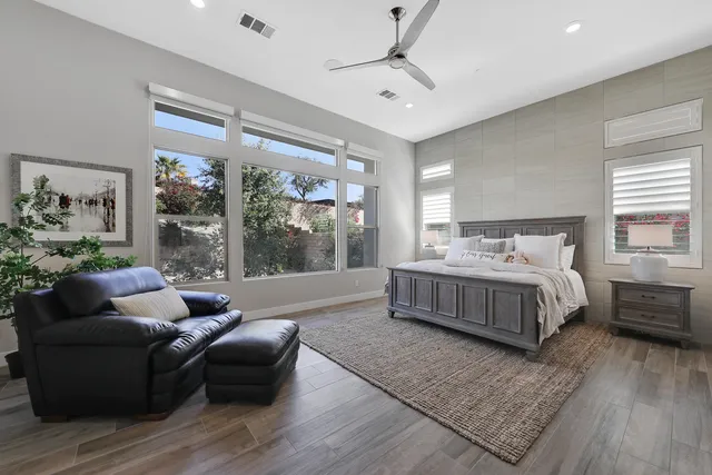 a bedroom with a bed and flat screen tv