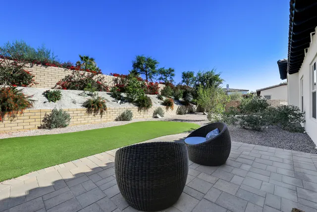 a view of a backyard with sitting area