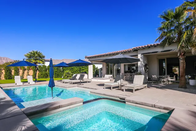 a view of a house with backyard porch and sitting area