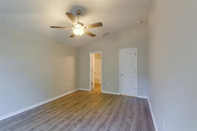 a view of an empty room and wooden floor