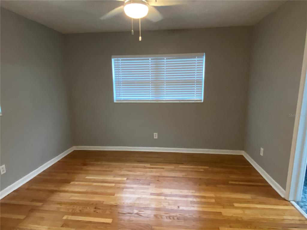 1908 West St Louis Street Tampa, FL 33607 - Photo 15 of 28 a view of a room with a ceiling fan and wooden floor