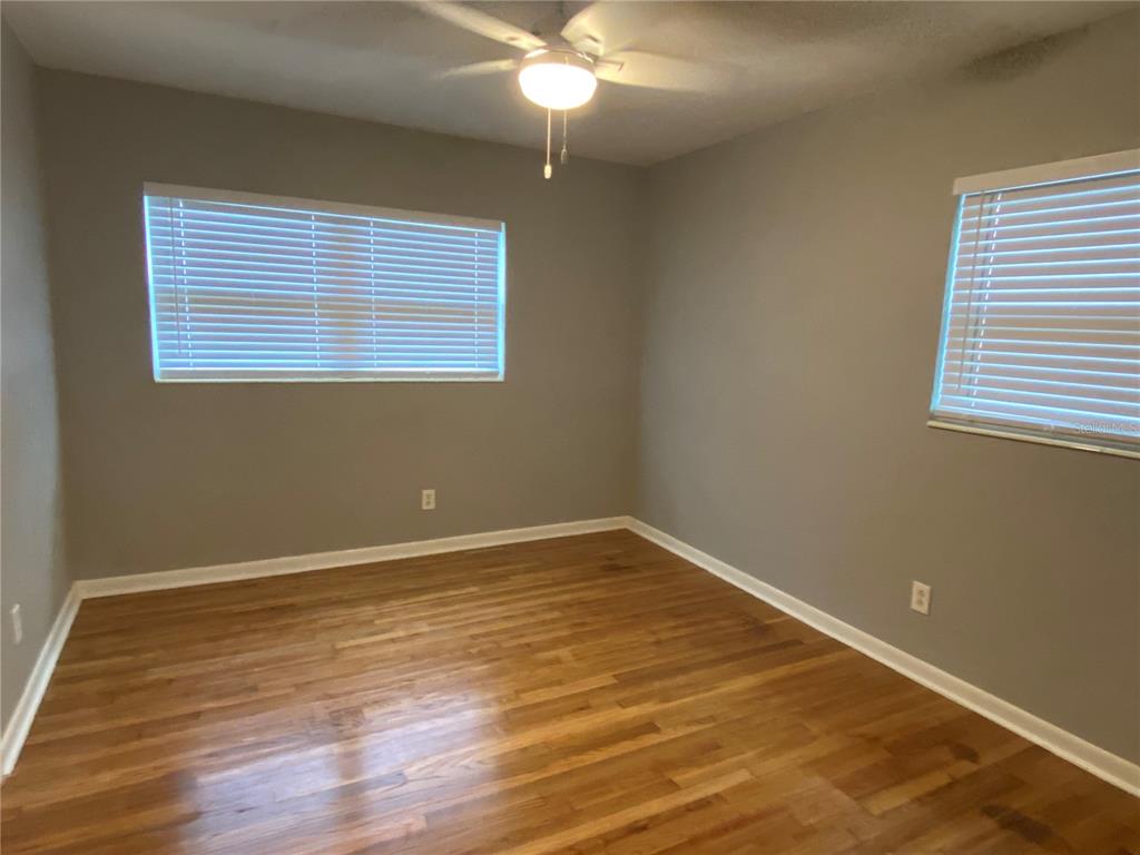 1908 West St Louis Street Tampa, FL 33607 - Photo 17 of 28 a view of an empty room with wooden floor and a window