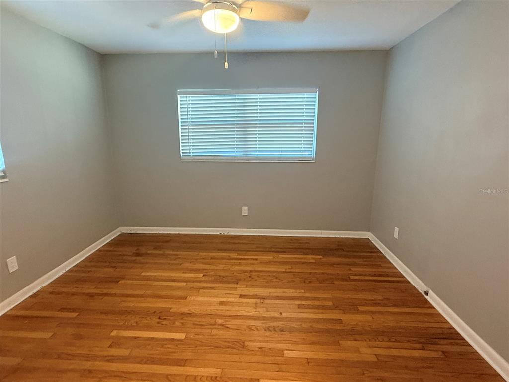 1908 West St Louis Street Tampa, FL 33607 - Photo 20 of 28 a view of an empty room with wooden floor and a window