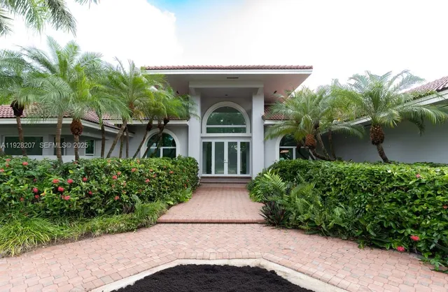 front view of a house with potted plants